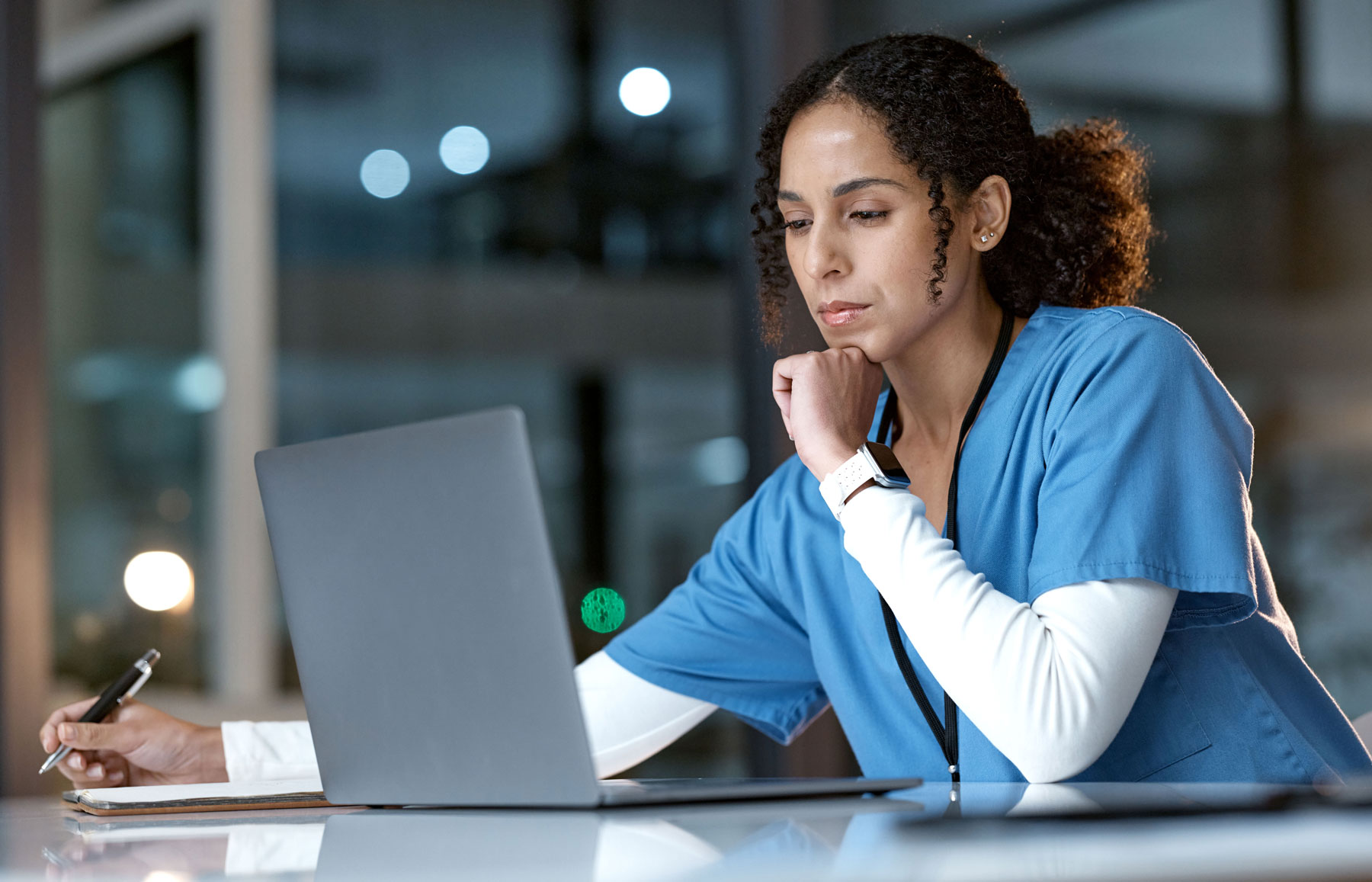 Nurses working on online certification on a laptop